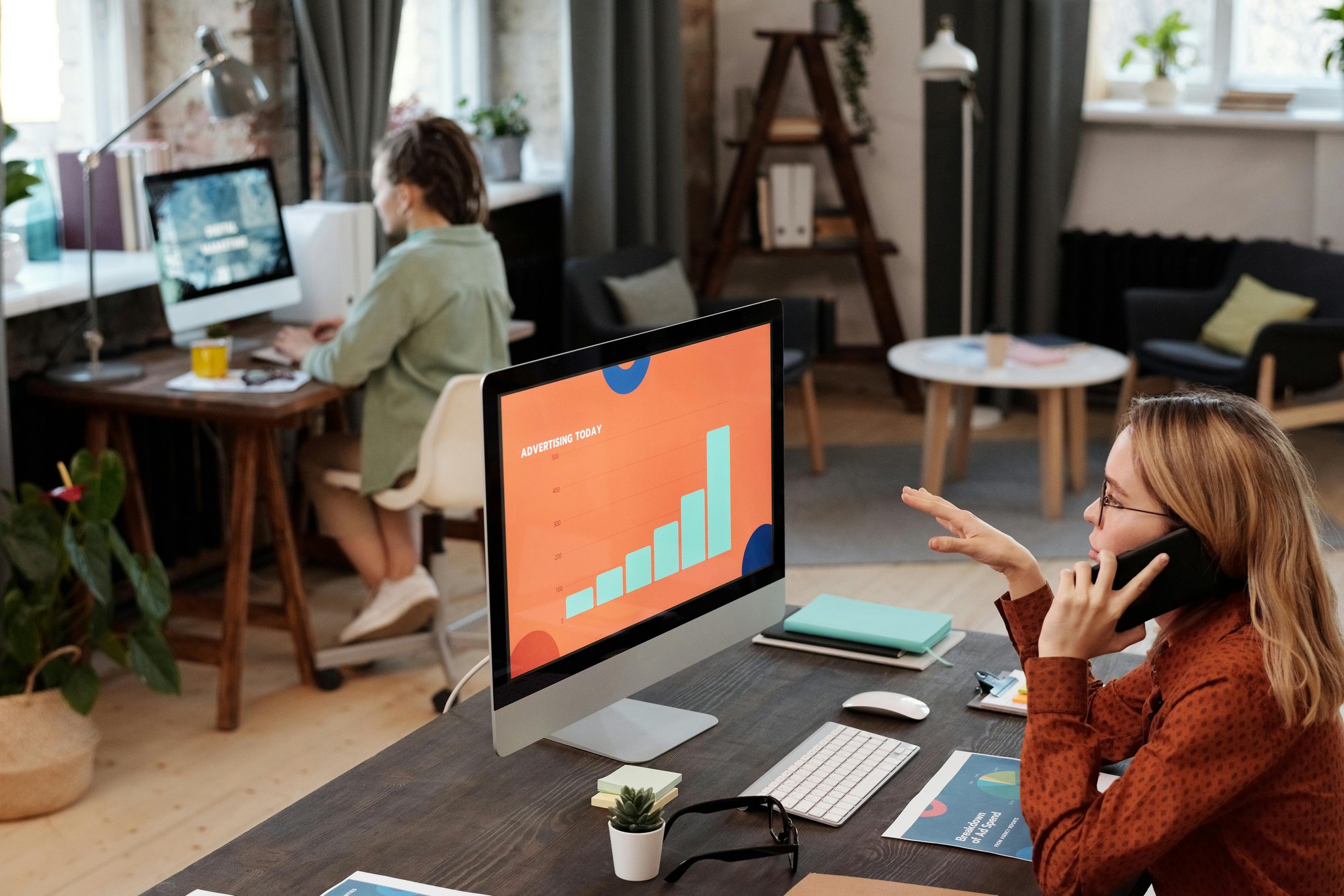 Photo of woman working at her desk on the phone